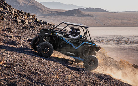 polaris rzr xp 1000 off-roading uphill on rocky terrain