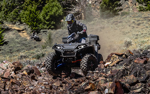 polaris sportsman xp 1000 atv crossing over rocky terrain with legendary ride and handling