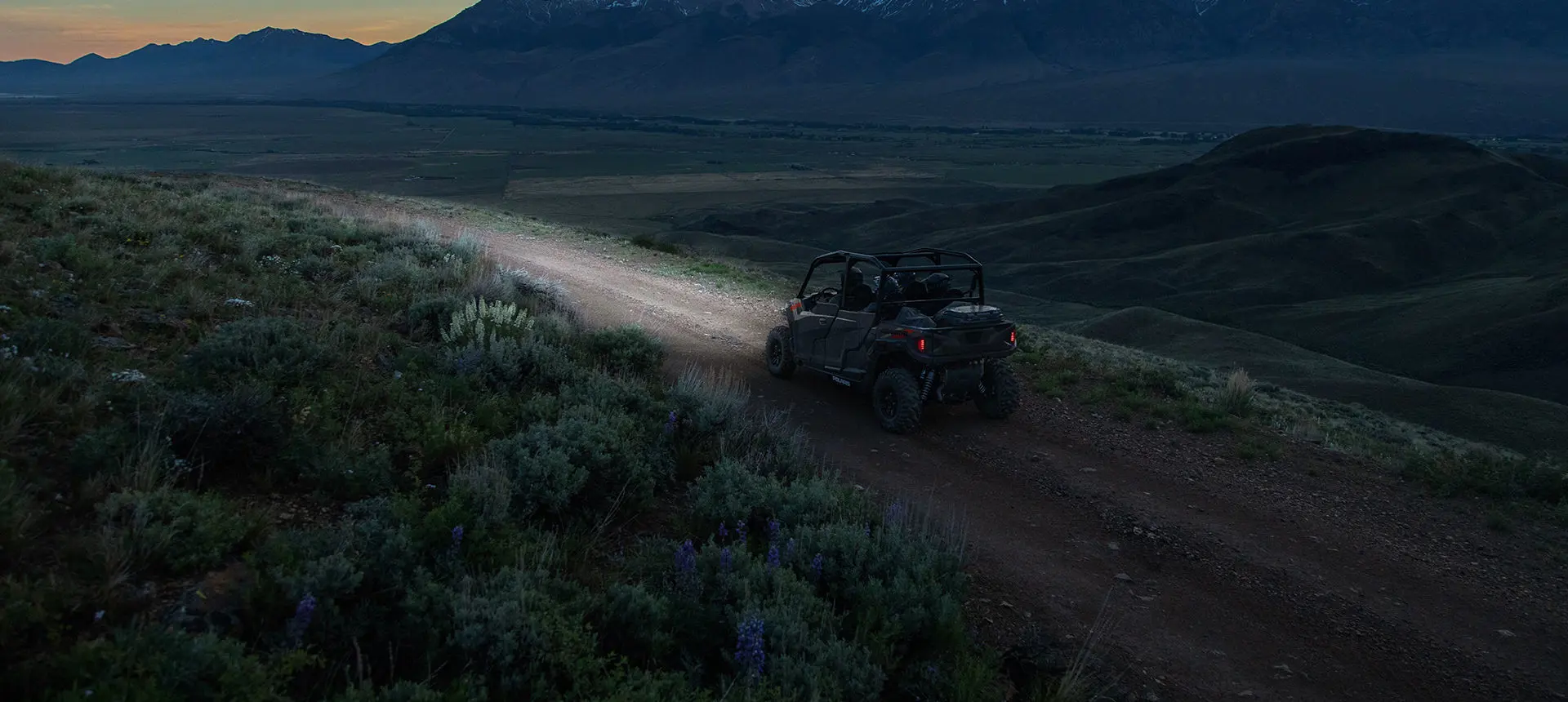 Polaris General 4 1000 side by side driving on a trail at night