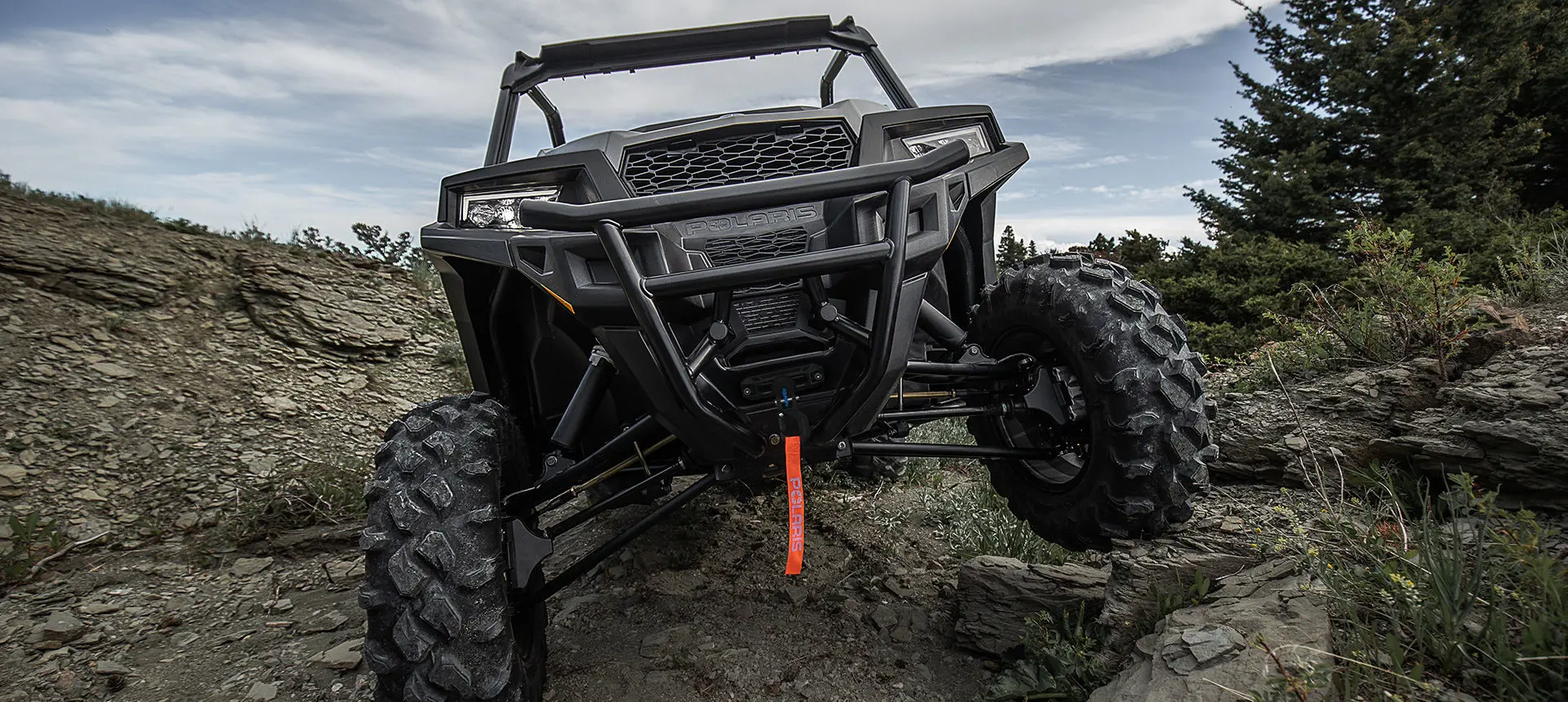 Polaris General 1000 side by side climbing over rocky terrain with ease