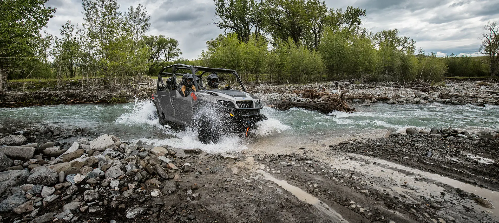 Polaris General 4 1000 side by side driving through a river