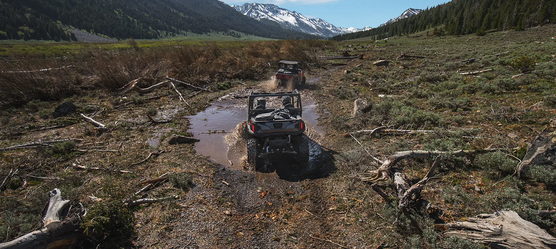 Polaris General 1000 side by side driving through a mud hole with ease