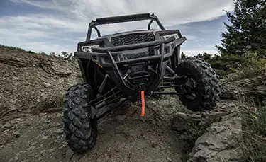 Polaris General 1000 side by side climbing over rocky terrain with ease