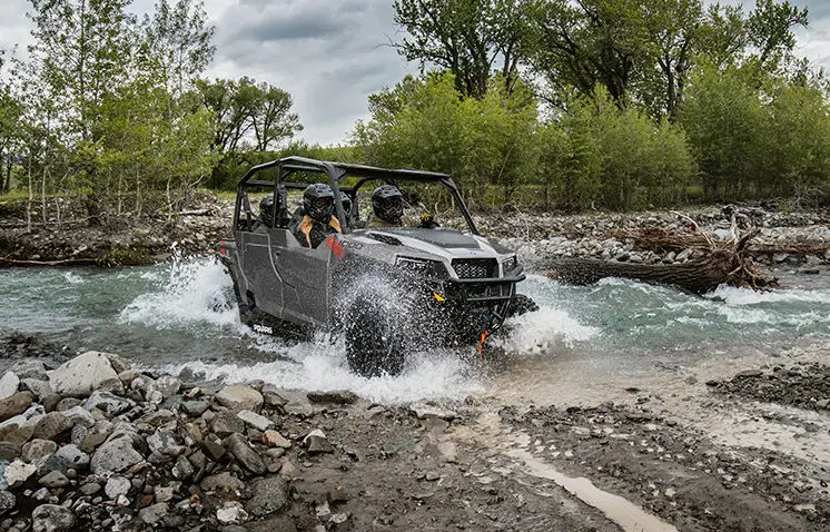 Polaris General 4 1000 side by side driving through a river