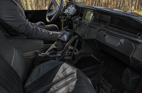 rider shifting in the comfortable interior of a Polaris General 1000 side by side