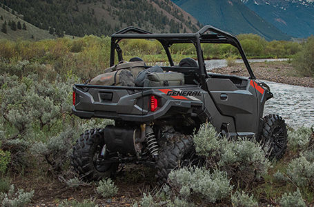 Polaris General 1000 side by side parked by a river