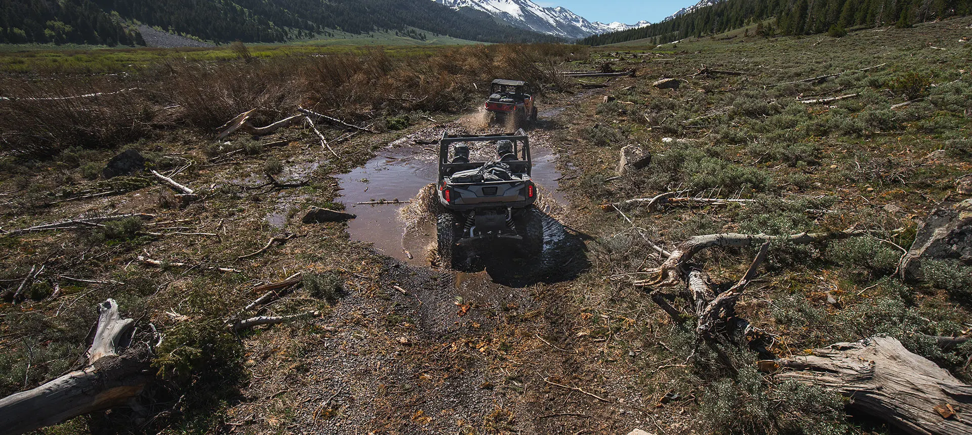Polaris General 4 1000 side by side hauling mountain bikes on a rocky trail