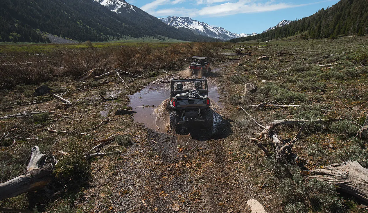 Polaris General 4 1000 side by side hauling mountain bikes on a rocky trail