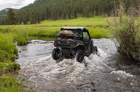 Polaris General xp 1000 side by side driving through a stream