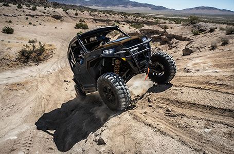 Polaris General XP 1000 side by side crawling up a sandy hill with unmatched performance