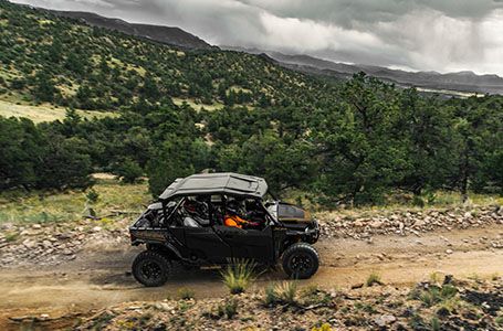 4 passengers riding comfortably in a Polaris General XP 1000 side by side on a rocky trail