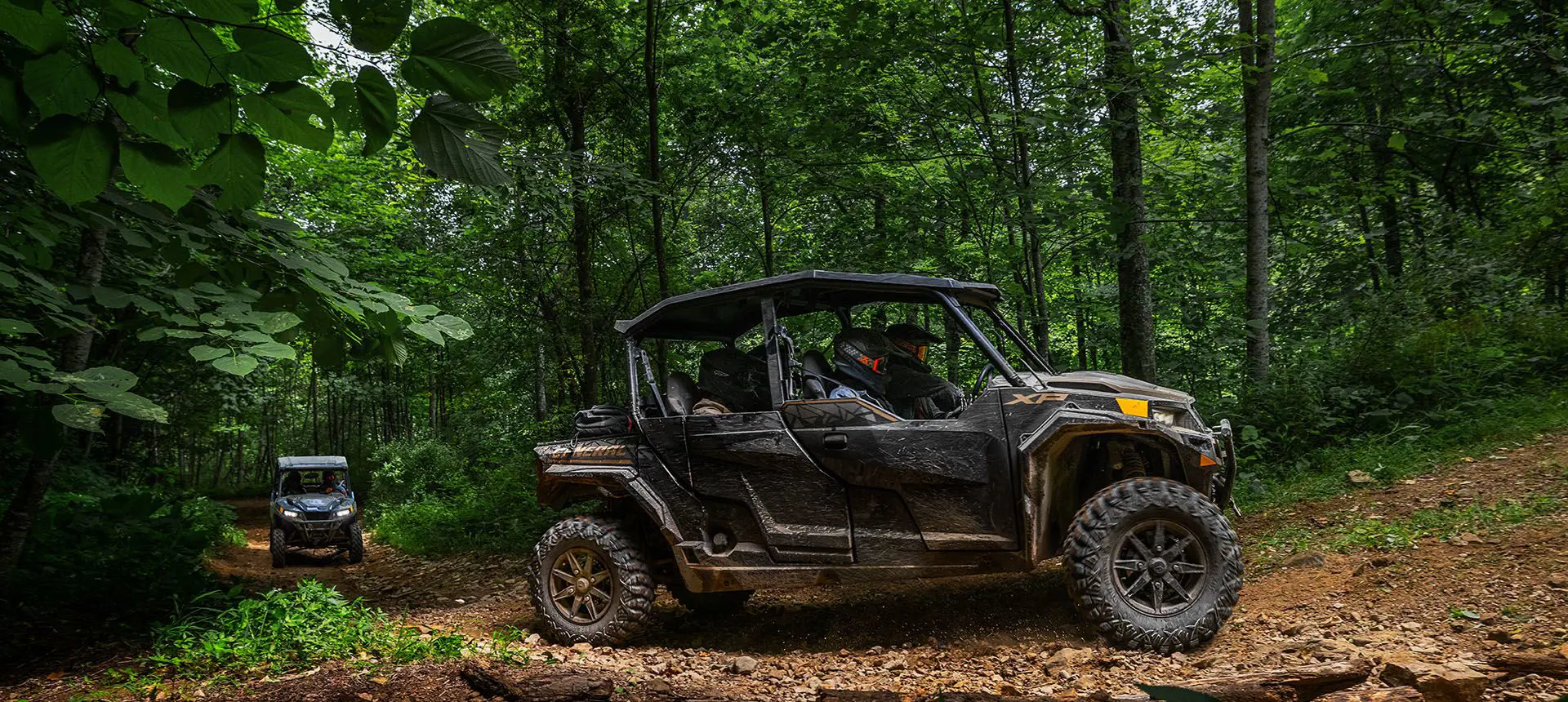 Fully loaded Polaris General XP 4 1000 side by side cruising on a forest trail