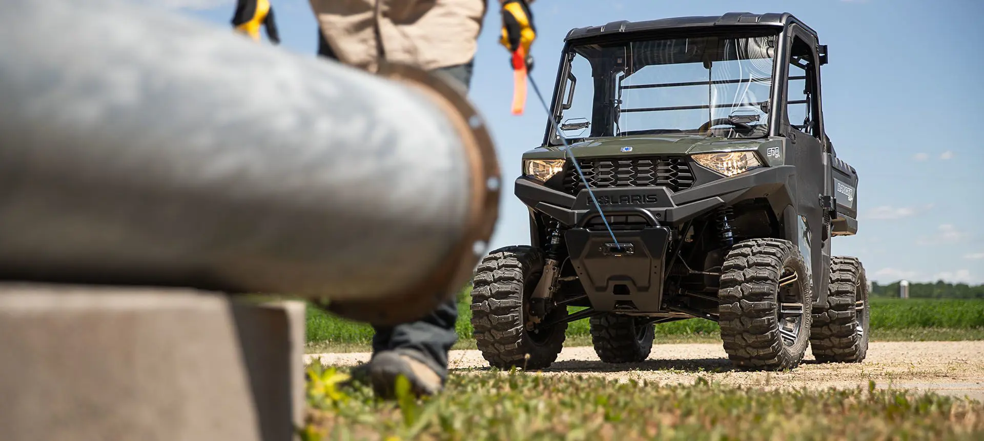 Man pulling out the winch installed on his RANGER SP 570