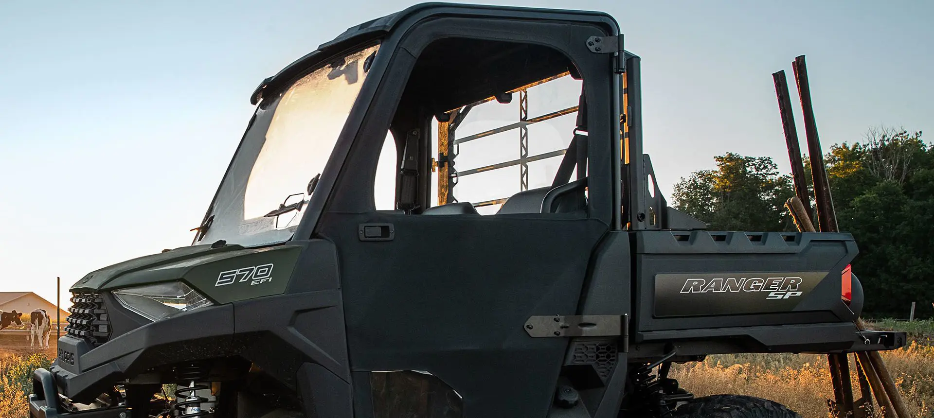 Farmer pounding in fence posts near his RANGER SP 570 with ranch collection accessories installed