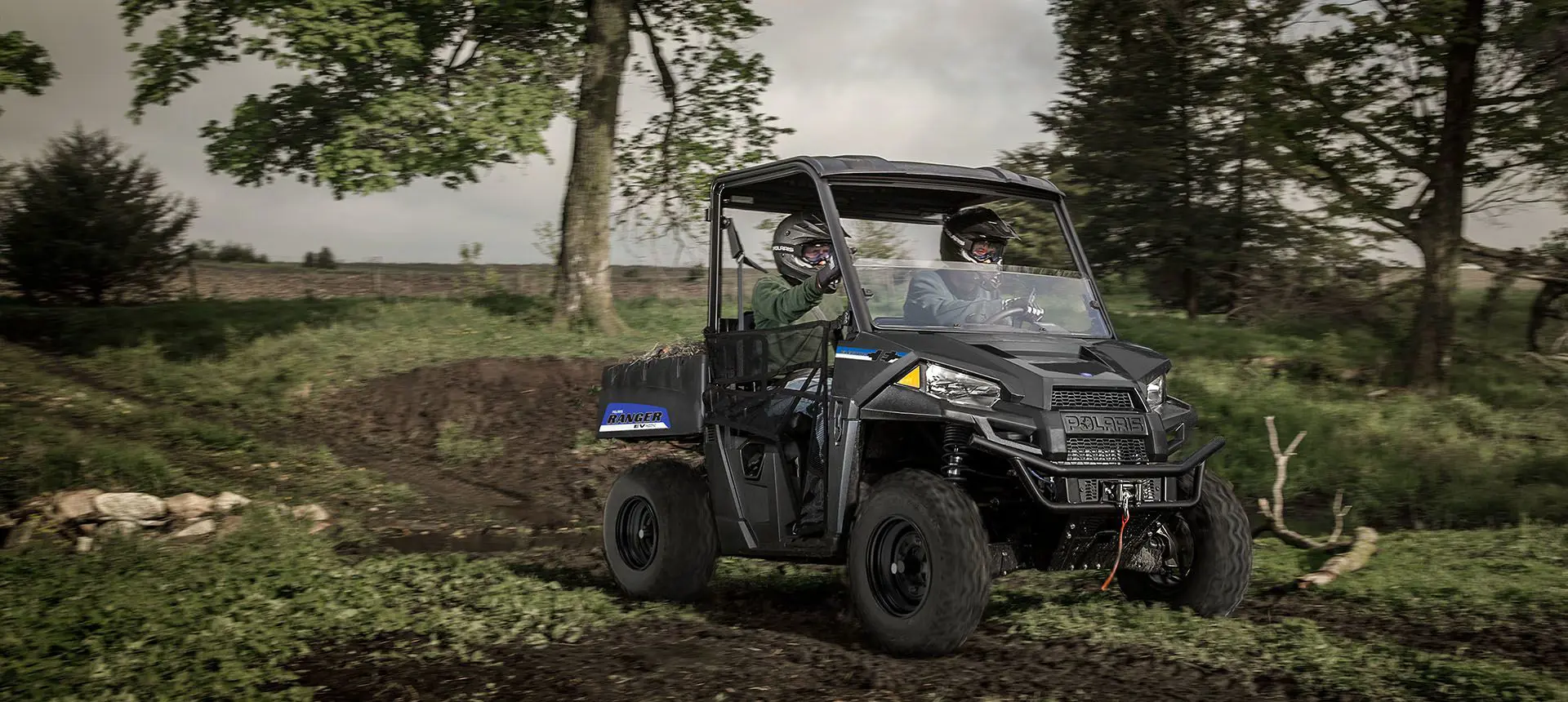 2 riders quietly trail riding in their polaris ranger ev
