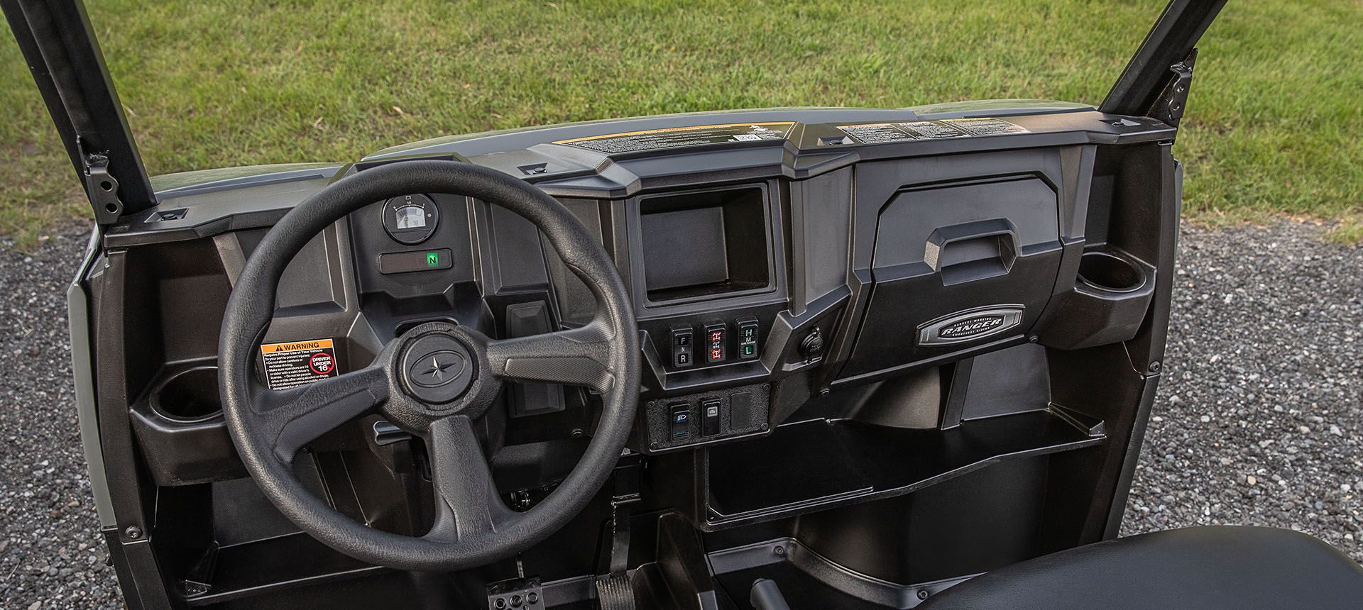 cockpit with adjustable tilt steering in the polaris ranger ev