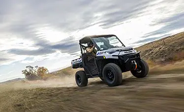 ranger xp kinetic side by side speeding down a trail