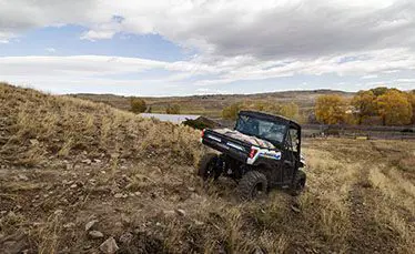 ranger xp kinetic side by side hauling goods down a hillside