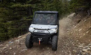 front view of a ranger xp kinetic side by side on a trail