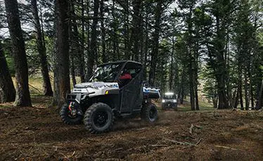 side view of a ranger xp kinetic side by side leading on a trail