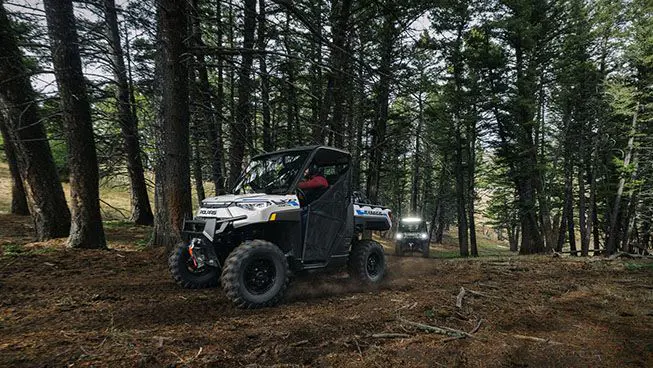 side view of a ranger xp kinetic utv leading on a trail