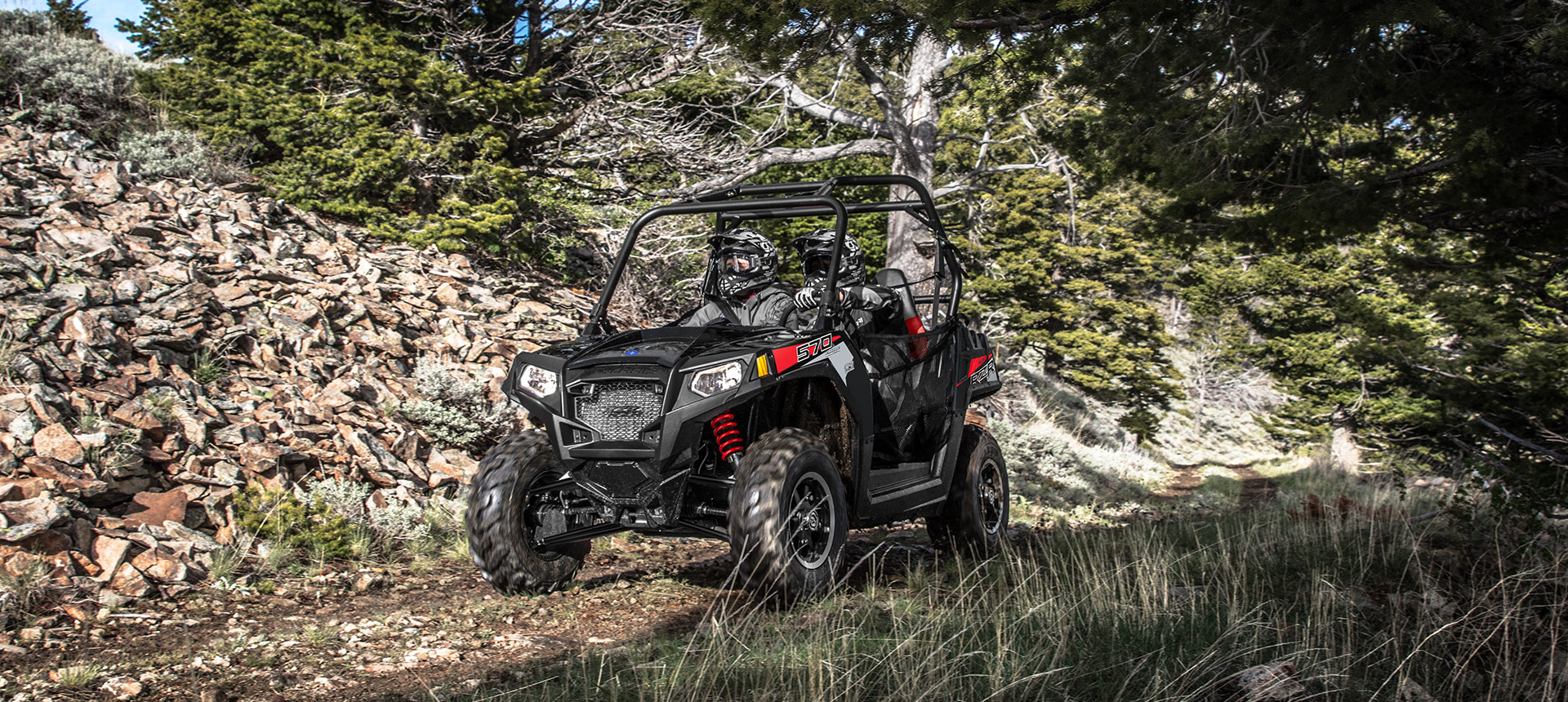 RZR trail 570 riding on a trail in the forest