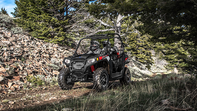 RZR trail 570 riding on a trail in the forest