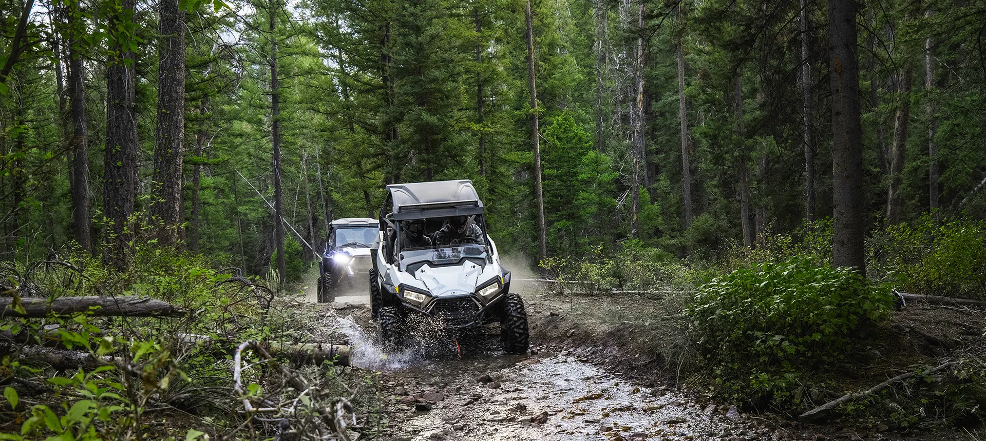 RZR trails riding through a muddy trail