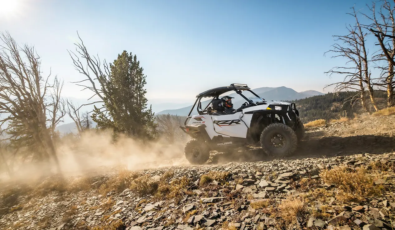 RZR trail cruising up a rocky hillside