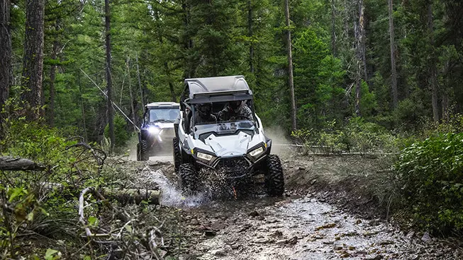 RZR trails riding through a muddy trail