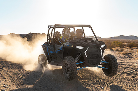 agile rzr xp 4 1000 cruising down a dusty trail