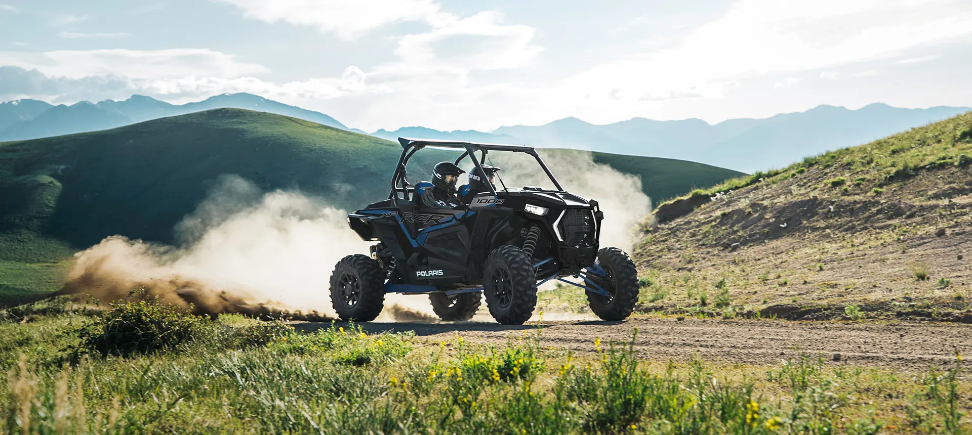 RZR XP 1000 riding on a trail near the mountains