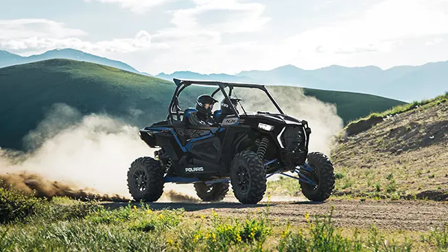 RZR XP 1000 riding on a trail near the mountains