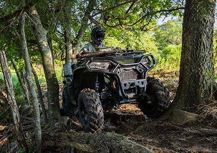 sportsman 570 crawling over big roots with on demand all-wheel drive