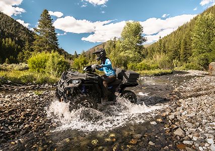 sportsman 570 traversing a stream with ease with its 44hp prostar engine