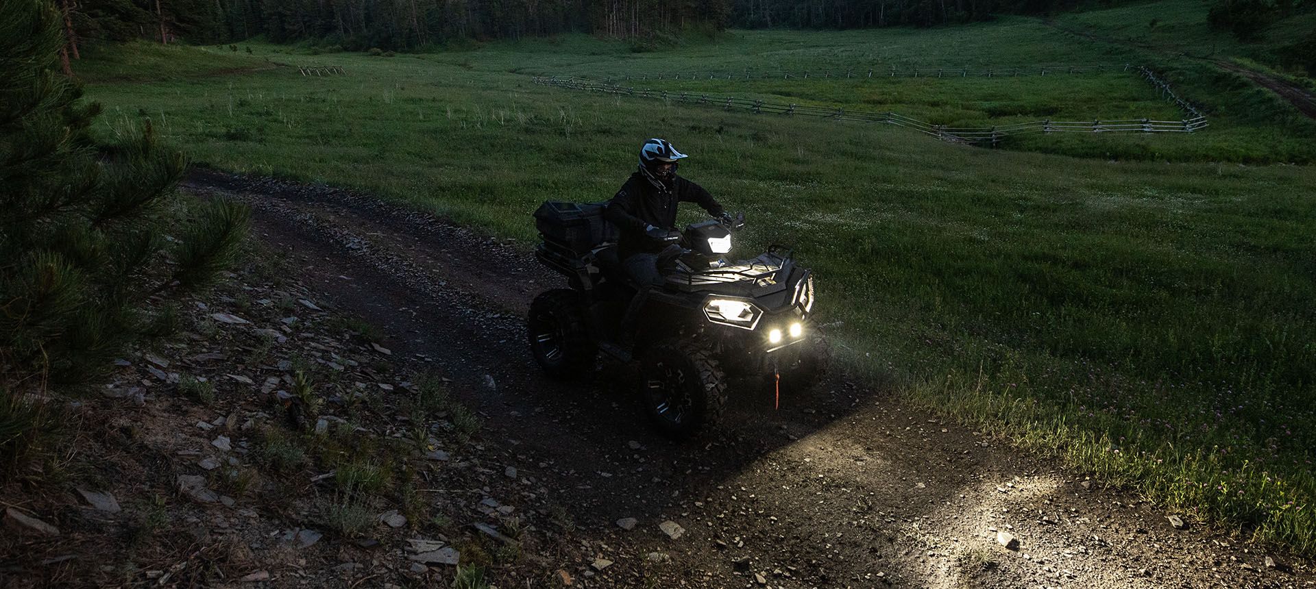 Sportsman 570 through a darker trail with Pro Armor lighting equipped