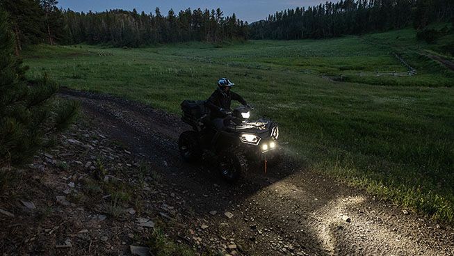 Sportsman 570 through a darker trail with Pro Armor lighting equipped