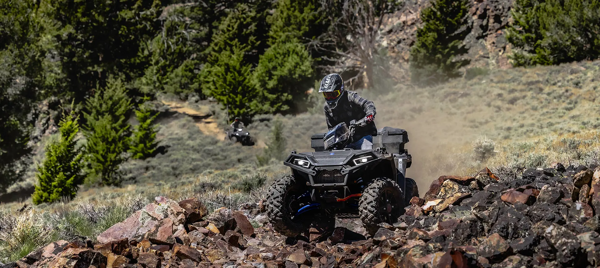 sportsman 850 with front and rear brushguard cruising down a rocky trail