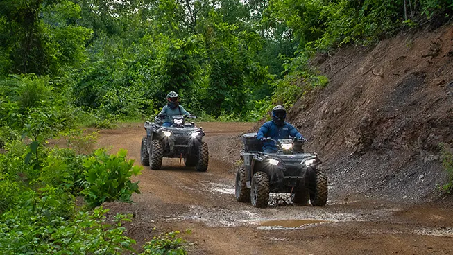 Two Sportsman 850 riding on a trail