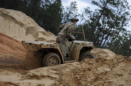 soldier driving the sportsman mv850 tactical atv up a rocky hill