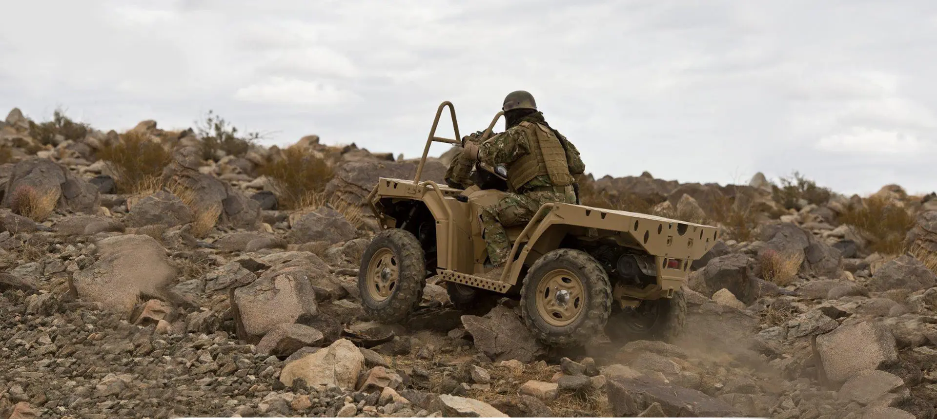 soldier driving a sportsman mv850 tactical atv on rough terrain