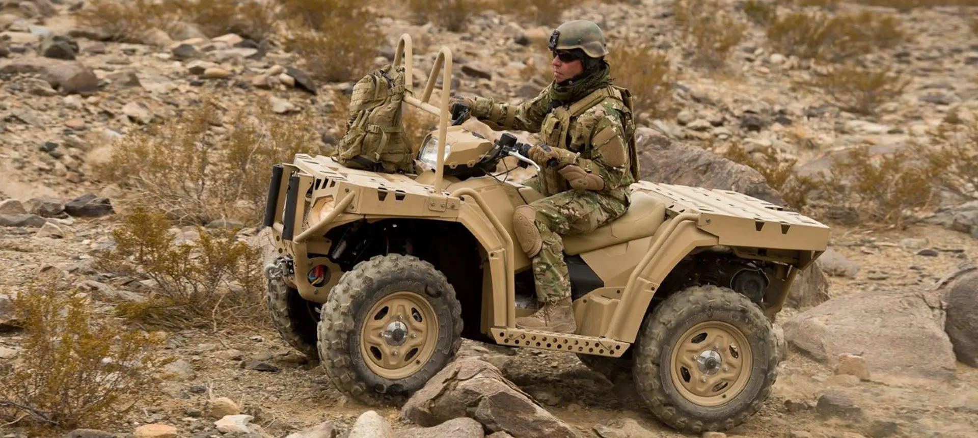 soldier driving a fully loaded sportsman mv850 tactical atv