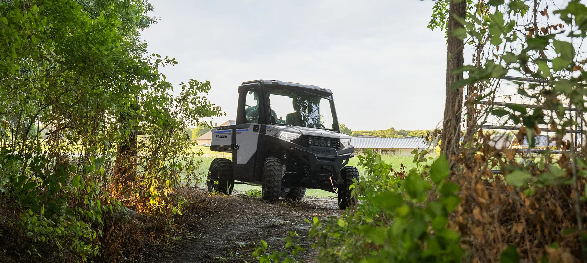 4 riders in a ranger crew sp 570 utv driving in a field