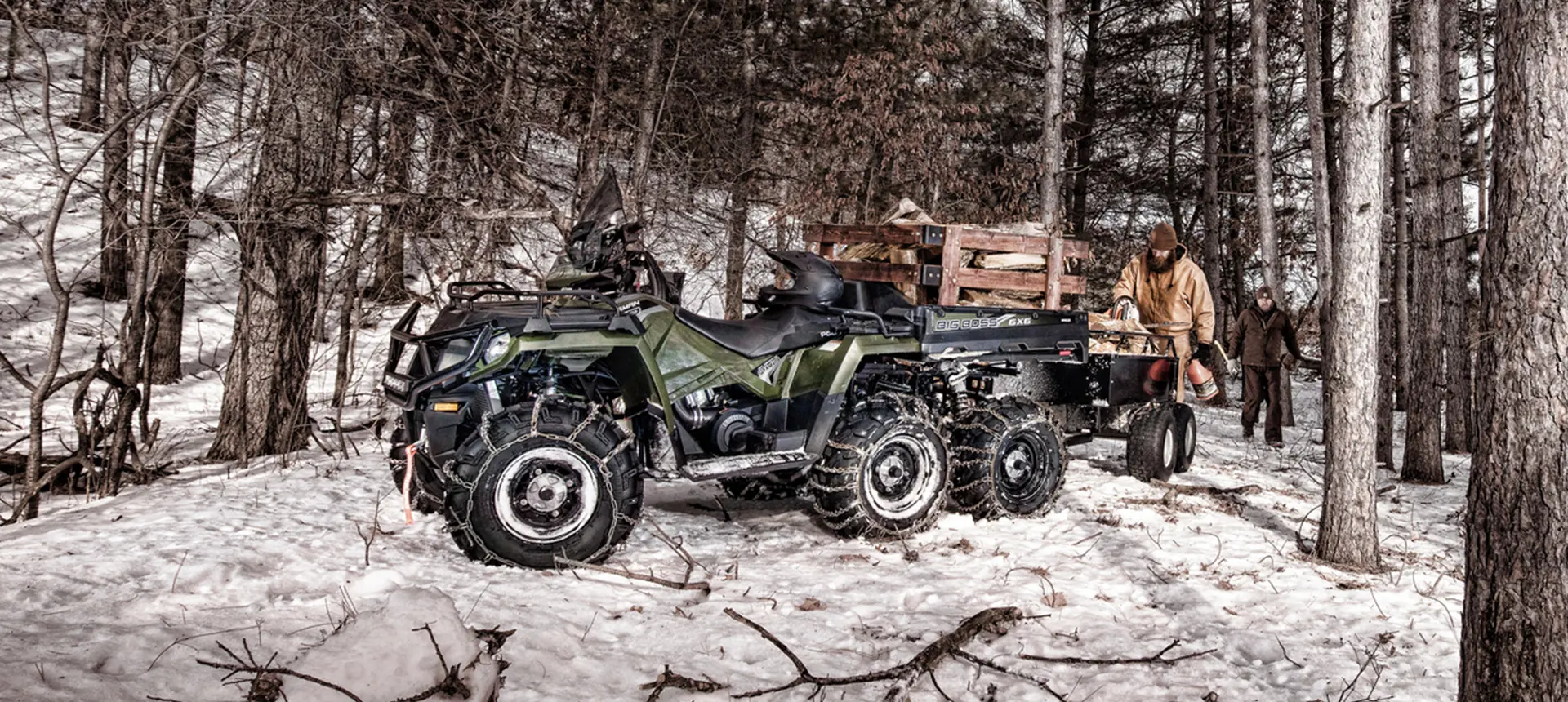 people using a sportsman 6x6 570 atv to move wood