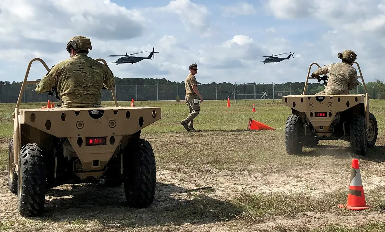 Two military training in their vehicles
