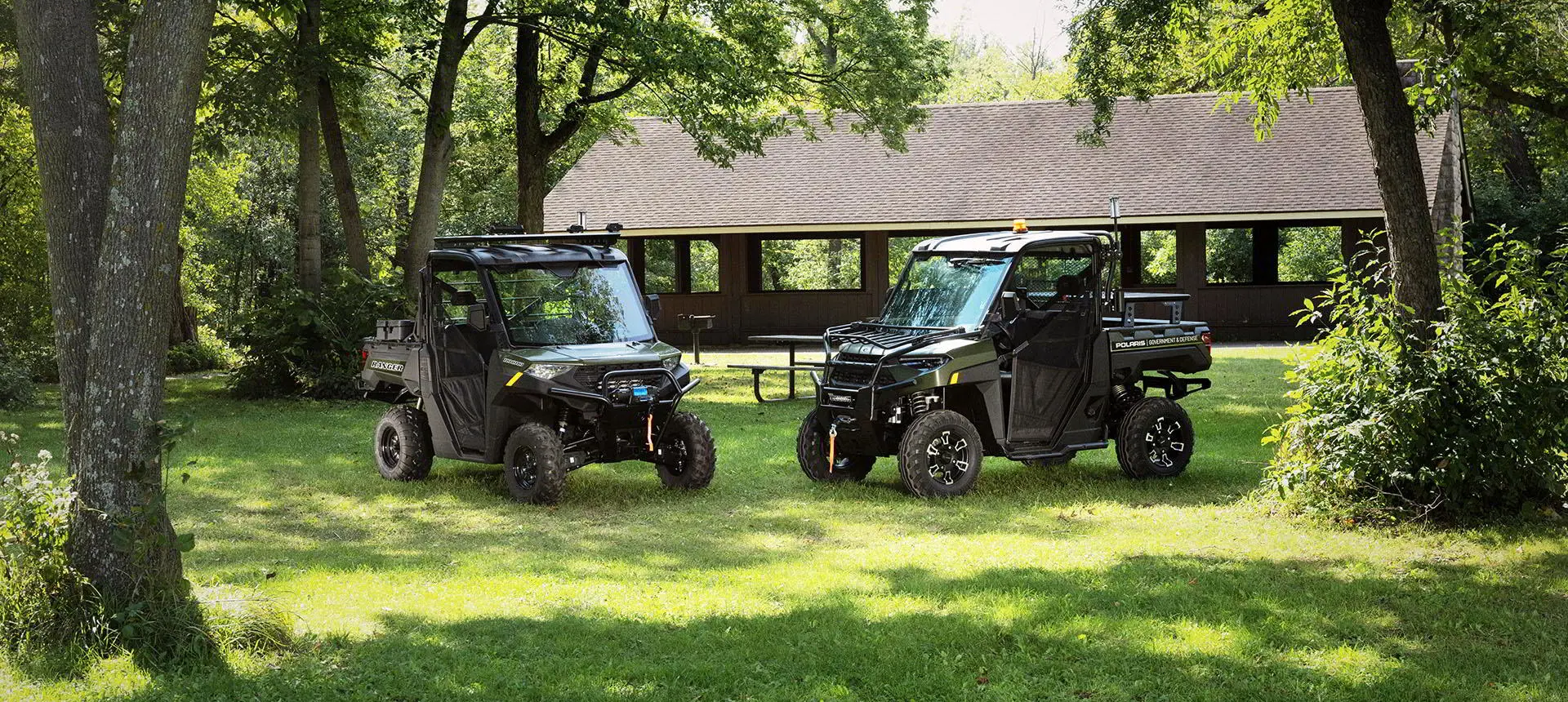 2 polaris rangers with terrain and wildlife management packages in a park