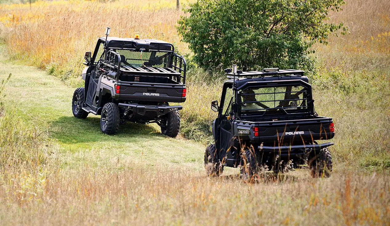 2 polaris rangers with terrain and wildlife management packages driving on a trail