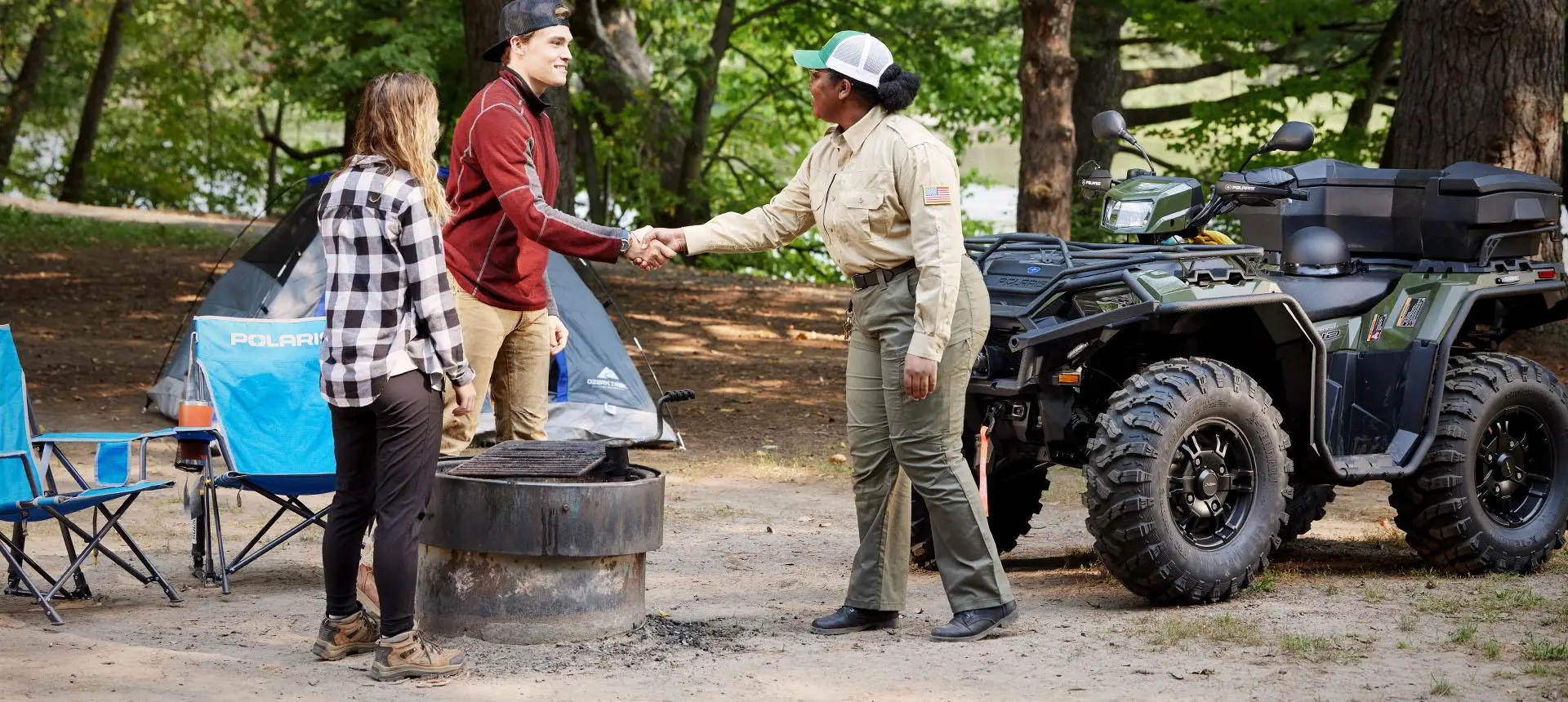 polaris sportsman atv with terrain and wildlife management package near a campsite