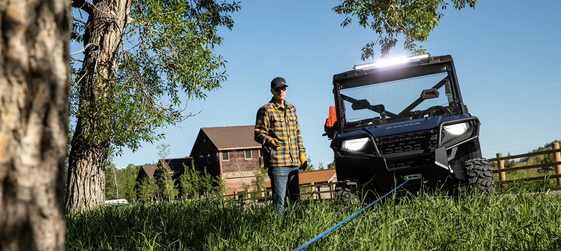 man using the winch on his ranger 1000 utv