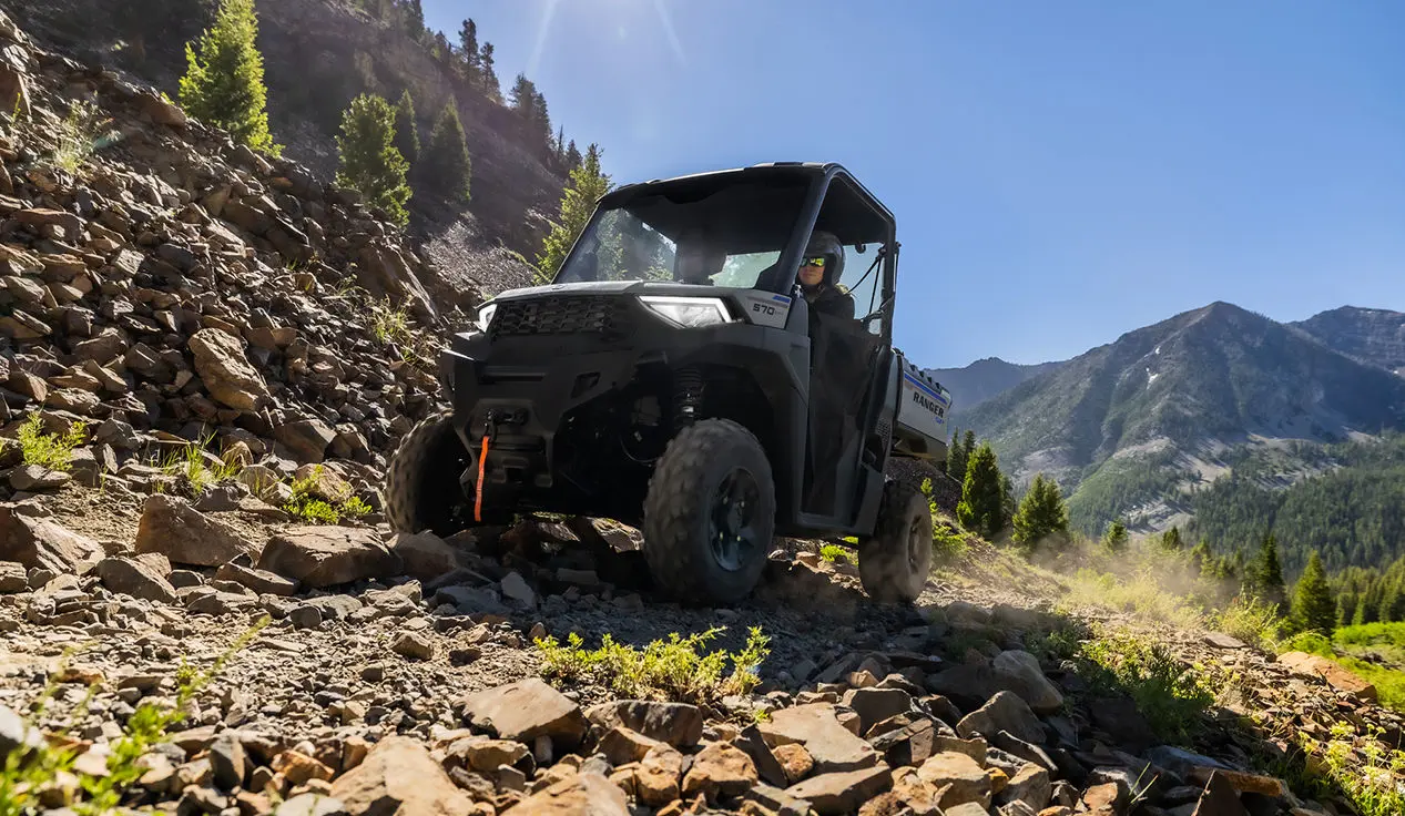 ranger sp 570 utv traveling over rocky terrain